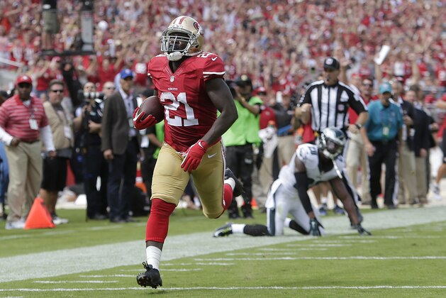 San Francisco 49ers running back Frank Gore (21) scores on a 55-yard touchdown reception against the Philadelphia Eagles during the second quarter of an NFL football game in Santa Clara, Calif., Sunday, Sept. 28, 2014. (AP Photo/Marcio Jose Sanchez)