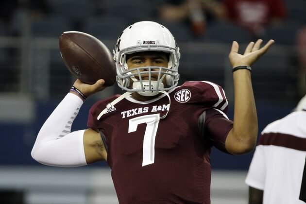 Texas A&M quarterback Kenny Hill passes as he warms up before an NCAA college football game against Arkansas, Saturday, Sept. 27, 2014, in Arlington, Texas. (AP Photo/Tony Gutierrez)