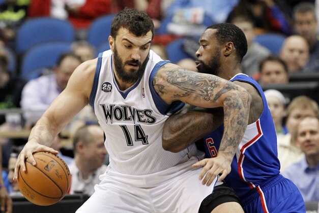 Minnesota Timberwolves center Nikola Pekovic (14), of Montenegro, drives against Los Angeles Clippers center DeAndre Jordan (6) during the first quarter of an NBA basketball game in Minneapolis, Monday, March 31, 2014.  (AP Photo/Ann Heisenfelt)