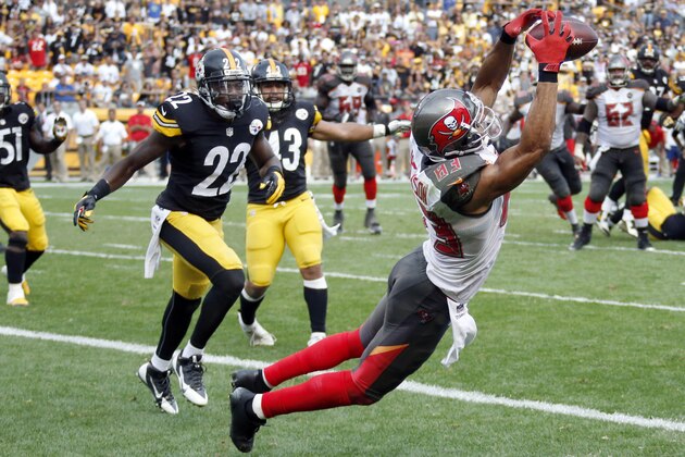 Tampa Bay Buccaneers wide receiver Vincent Jackson (83) makes a catch in front of Pittsburgh Steelers cornerback William Gay (22) for a touchdown with seven seconds left in the fourth quarter of an NFL football game on Sunday, Sept. 28, 2014 in Pittsburgh. The score lifted the Buccaneers to a 27-24 win. (AP Photo/Gene Puskar)