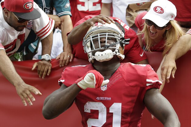 San Francisco 49ers running back Frank Gore (21) celebrates with fans after scoring on a 55-yard touchdown reception against the Philadelphia Eagles during the second quarter of an NFL football game in Santa Clara, Calif., Sunday, Sept. 28, 2014. (AP Photo/Marcio Jose Sanchez)