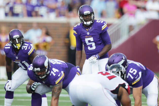 Minnesota Vikings quarterback Teddy Bridgewater (5) calls a play at the line of scrimmage during the first half of an NFL football game against the Atlanta Falcons, Sunday, Sept. 28, 2014, in Minneapolis. (AP Photo/Jim Mone)
