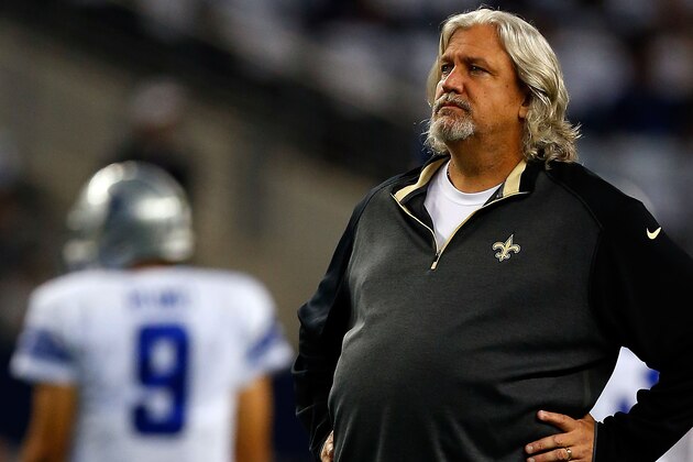 ARLINGTON, TX - SEPTEMBER 28: Defensive Coordinator Rob Ryan of the New Orleans Saints walks the field as Tony Romo #9 of the Dallas Cowboys stands in the background before the start of the game at AT&T Stadium on September 28, 2014 in Arlington, Texas.  (Photo by Tom Pennington/Getty Images)