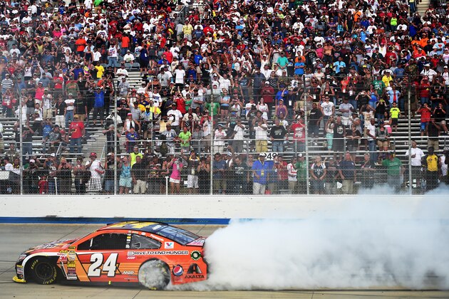 DOVER, DE - SEPTEMBER 28:  Jeff Gordon, driver of the #24 Drive To End Hunger Chevrolet, celebrates with a burnout after winning the NASCAR Sprint Cup Series AAA 400 at Dover International Speedway on September 28, 2014 in Dover, Delaware.  (Photo by Patrick Smith/Getty Images)