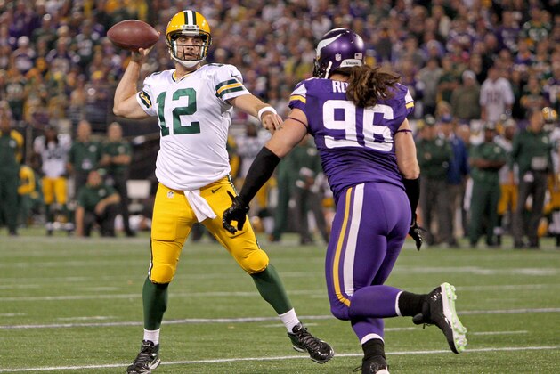 Oct 27, 2013; Minneapolis, MN, USA; Green Bay Packers quarterback Aaron Rodgers (12) throws over Minnesota Vikings defensive end Brian Robison (96) during the third quarter at Mall of America Field at H.H.H. Metrodome. The Packers defeated the Vikings 44-31. Mandatory Credit: Brace Hemmelgarn-USA TODAY Sports
