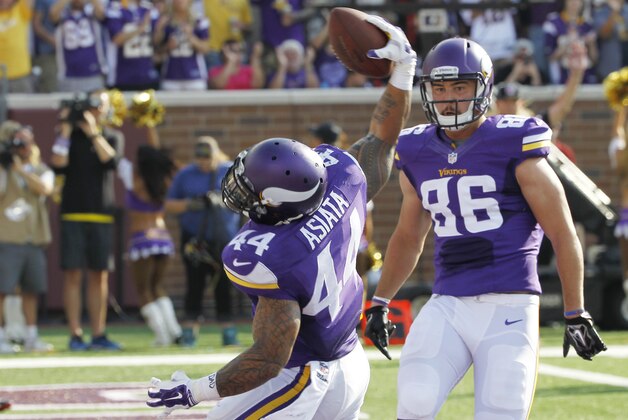 Minnesota Vikings running back Matt Asiata celebrates with teammate Chase Ford (86) after scoring on a 6-yard touchdown run in the first half of an NFL football game against the Atlanta Falcons, Sunday, Sept. 28, 2014, in Minneapolis. (AP Photo/Ann Heisenfelt)