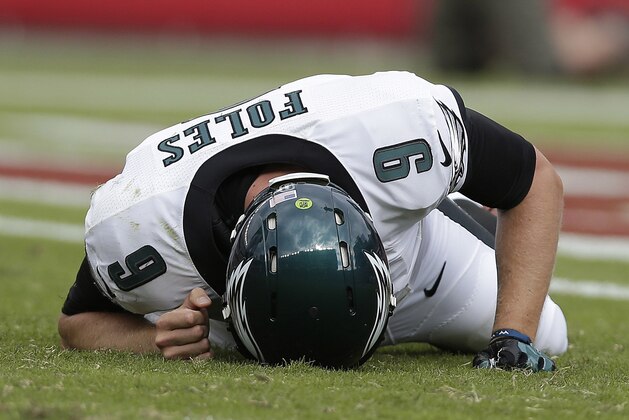 Philadelphia Eagles quarterback Nick Foles lies facedown on the field after being hit after an incomplete pass during the fourth quarter of an NFL football game against the San Francisco 49ers in Santa Clara, Calif., Sunday, Sept. 28, 2014. (AP Photo/Marcio Jose Sanchez)