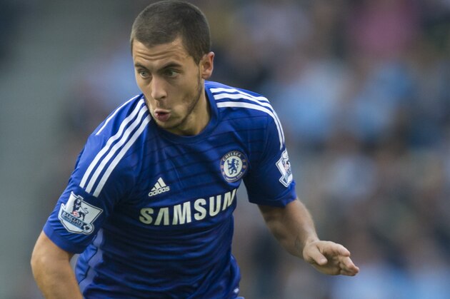 Chelsea's Eden Hazard takes the ball downfield during his team's English Premier League soccer match against Manchester City at the Etihad Stadium, Manchester, England, Sunday Sept. 21, 2014. (AP Photo/Jon Super)