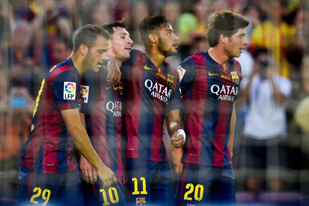 BARCELONA, SPAIN - SEPTEMBER 27:  Lionel Messi (2ndL) of FC Barcelona celebrates with his teammates (L-R) Sandro, Neymar and Sergio Roberto of FC Barcelona after scoring his team's sixth goal during the La Liga match between FC Barcelona and Granada CF at Camp Nou on September 27, 2014 in Barcelona, Spain.  (Photo by David Ramos/Getty Images)