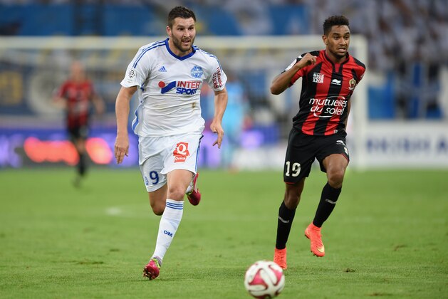 MARSEILLE, FRANCE - AUGUST 29:  Andre-Pierre Gignac of Marseille and Jordan Amavi of Nice during the French Ligue 1 match between Olympique de Marseille and OGC Nice at Stade Velodrome on August 29, 2014 in Marseille, France.  (Photo by Kaz Photography/Getty Images)