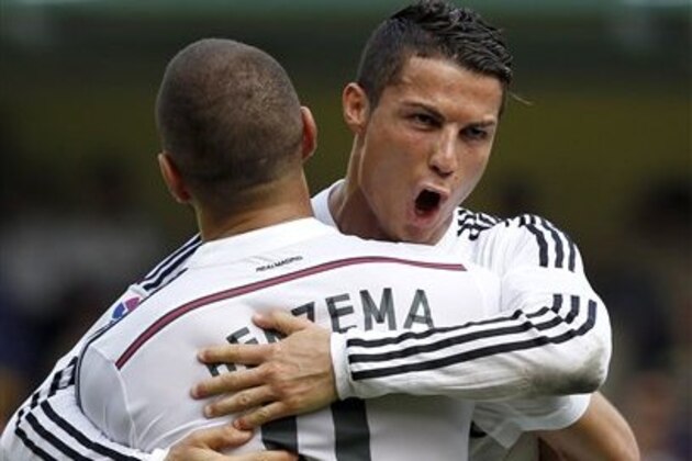 Real Madrid's Cristiano Ronaldo, right, from Portugal celebrates with Karim Benzema, from France, after scoring against Villarreal during a Spanish La Liga soccer match at the Madrigal stadium in Villarreal, Spain, on Saturday, Sept. 27, 2014.(AP Photo/Alberto Saiz)