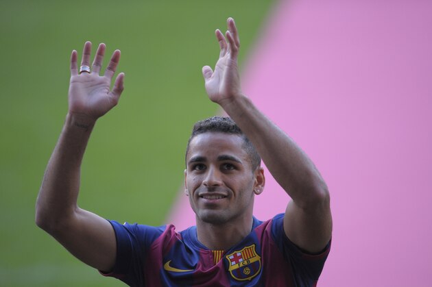 FC Barcelona's new Brazilian player Douglas Pereira gestures during his official presentation at the Camp Nou stadium in Barcelona, Spain, Friday, Aug. 29, 2014. Barcelona says it has agreed to sign defender Douglas Pereira from Sao Paulo on a five-season deal for 4 million euros ($5.3 million). (AP Photo/Manu Fernandez)