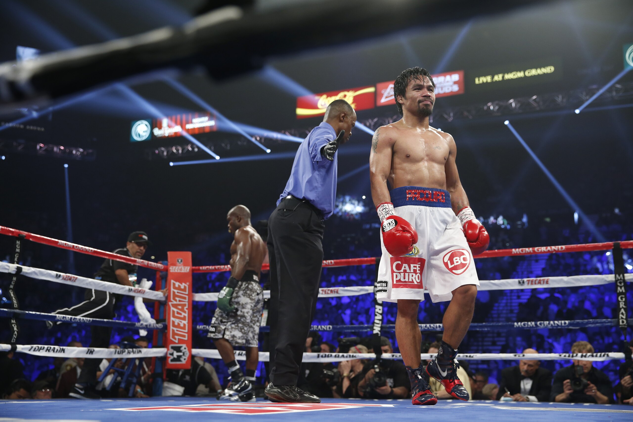 Referee Kenny Bayless, center, sends fighters Timothy Bradley, left, and Manny Pacquiao to their corners in their WBO welterweight title boxing fight Saturday, April 12, 2014, in Las Vegas. (AP Photo/Eric Jamison)