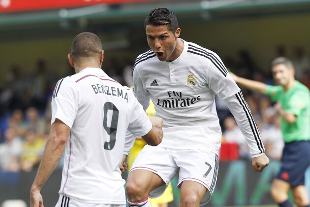 Real Madrid's Cristiano Ronaldo, from Portugal celebrates with Karim Benzema, left, from France, after scoring against Villarreal during a Spanish La Liga soccer match at the Madrigal stadium in Villarreal, Spain, on Saturday, Sept. 27, 2014.(AP Photo/Alberto Saiz)