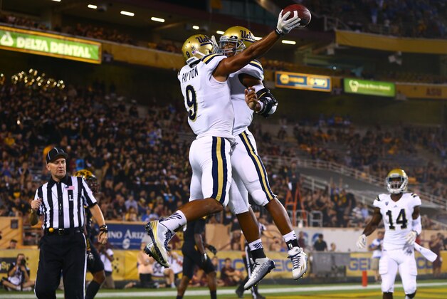 Sep 25, 2014; Tempe, AZ, USA; UCLA Bruins wide receiver Jordan Payton (left) celebrates a touchdown with quarterback Brett Hundley in the fourth quarter against the Arizona State Sun Devils at Sun Devil Stadium. UCLA defeated Arizona State 62-27. Mandatory Credit: Mark J. Rebilas-USA TODAY Sports