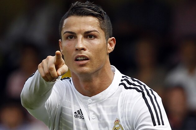 Real Madrid's Cristiano Ronaldo, from Portugal, celebrates after scoring against Villarreal during a Spanish La Liga soccer match at the Madrigal stadium in Villarreal, Spain, on Saturday, Sept. 27, 2014. (AP Photo/Alberto Saiz)
