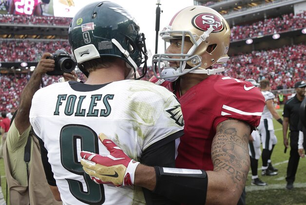 San Francisco 49ers quarterback Colin Kaepernick, right, greets Philadelphia Eagles quarterback Nick Foles (9) after an NFL football game in Santa Clara, Calif., Sunday, Sept. 28, 2014. The 49ers won 26-21. (AP Photo/Marcio Jose Sanchez)
