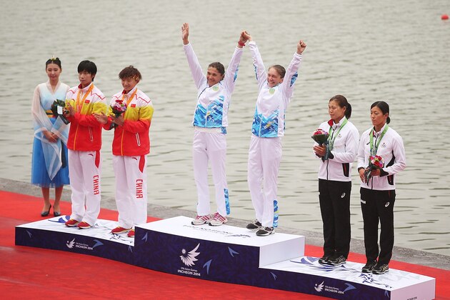 INCHEON, SOUTH KOREA - SEPTEMBER 29:  Gold medalist, Natalya Sergeyeva and Irina Pdoinikova of Kazakhstan, Silver medalist Ren Wenjuna and Ma Qing of China and Bronze medalist, Asumi Ohmura and Shiho Kakizaki of Japan celebrate atop the podium following the Women's K2 500m Final during day ten of the 2014 Asian Games at Hanam Misari Canoe/Kayak Center on September 29, 2014 in Incheon, South Korea.  (Photo by Brendon Thorne/Getty Images)