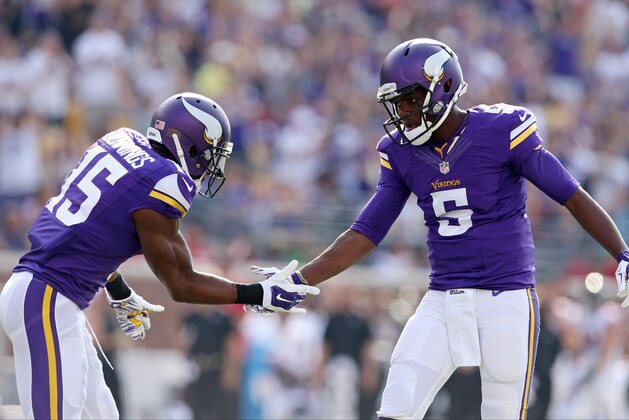 Sep 28, 2014; Minneapolis, MN, USA; Minnesota Vikings quarterback Teddy Bridgewater (5) celebrates a touchdown with wide receiver Greg Jennings (15) during the first quarter against the Atlanta Falcons at TCF Bank Stadium. Mandatory Credit: Brace Hemmelgarn-USA TODAY Sports