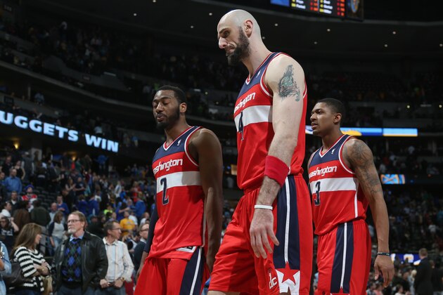 From left, Washington Wizards guard John Wall, center Marcin Gortat, of Poland, and guard Bradley Beal head to the locker room after the Denver Nuggets' 105-102 victory over the Wizards in an NBA basketball game in Denver on Sunday, March 23, 2014. (AP Photo/David Zalubowski)