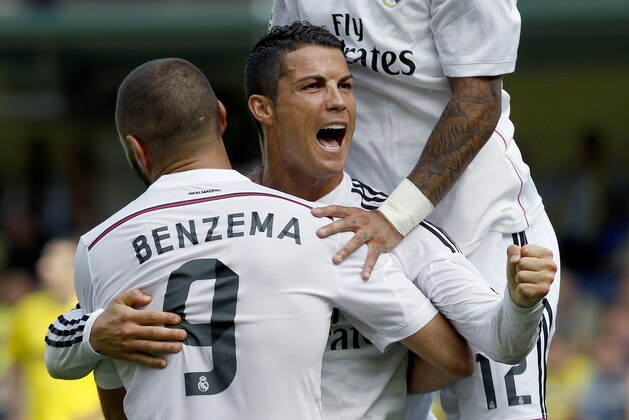 Real Madrid's Cristiano Ronaldo, from Portugal celebrates with Karim Benzema, from France, after scoring against Villarreal during a Spanish La Liga soccer match at the Madrigal stadium in Villarreal, Spain, on Saturday, Sept. 27, 2014.(AP Photo/Alberto Saiz)