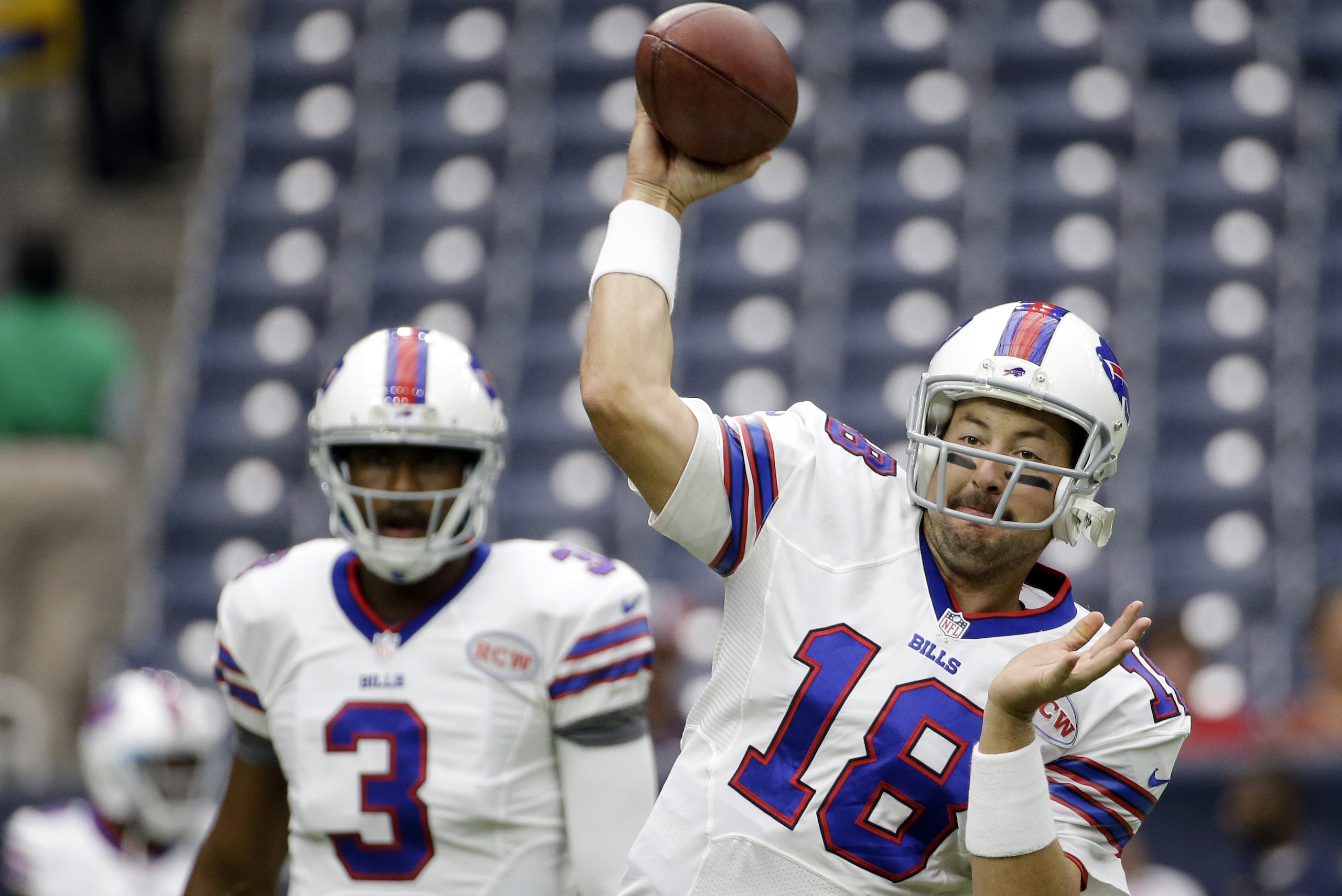 Buffalo Bills' Kyle Orton (18) throws as EJ Manuel (3) looks on prior to an NFL football game against the Houston, Sunday, Sept. 28, 2014, in Houston. (AP Photo/David J. Phillip)