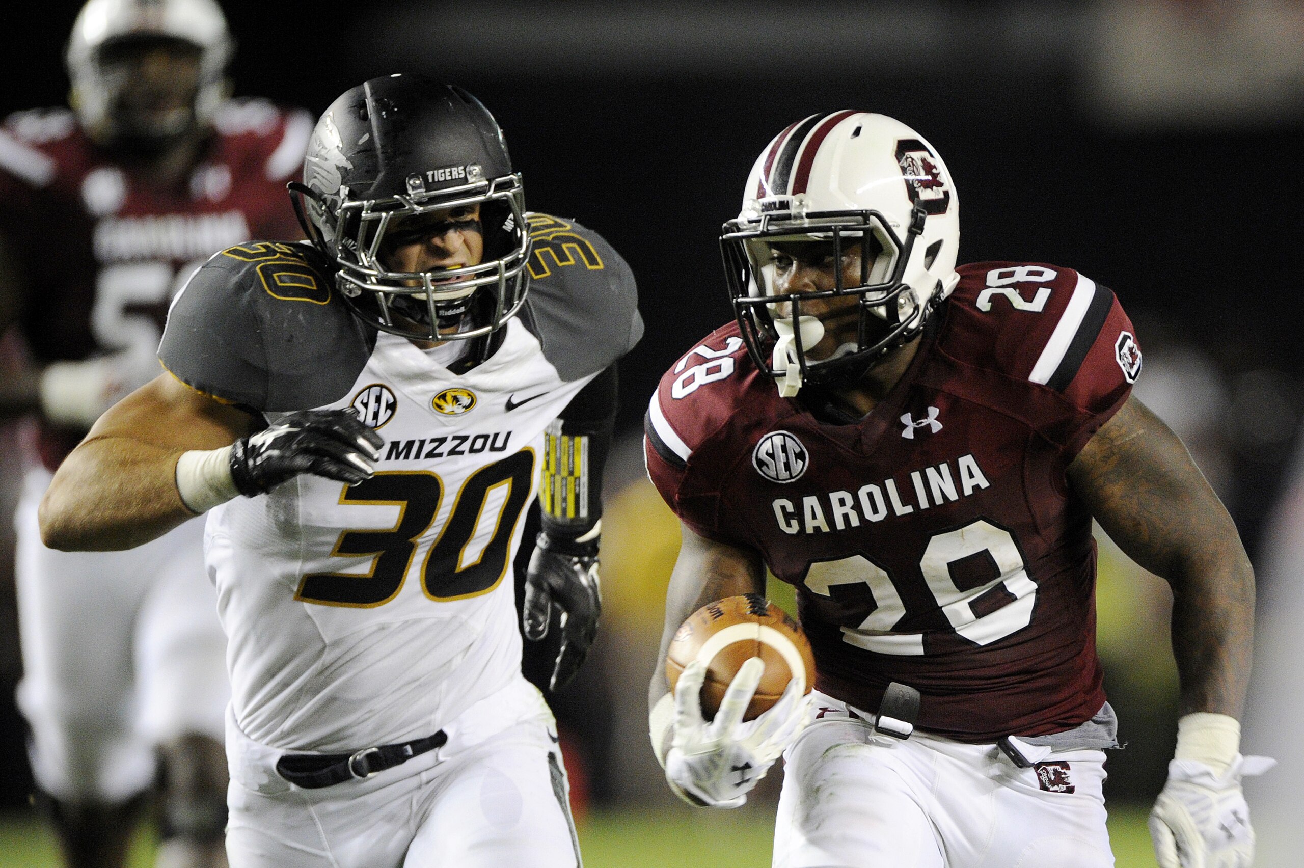 COLUMBIA, SC - SEPTEMBER 27:   Tailback Mike Davis #28 of the South Carolina Gamecocks tries to outrun linebacker Michael Scherer #30 of the Missouri Tigers during the second quarter on September 27, 2014 at Williams-Brice Stadium in Columbia, South Carolina.  (Photo by Todd Bennett/GettyImages)