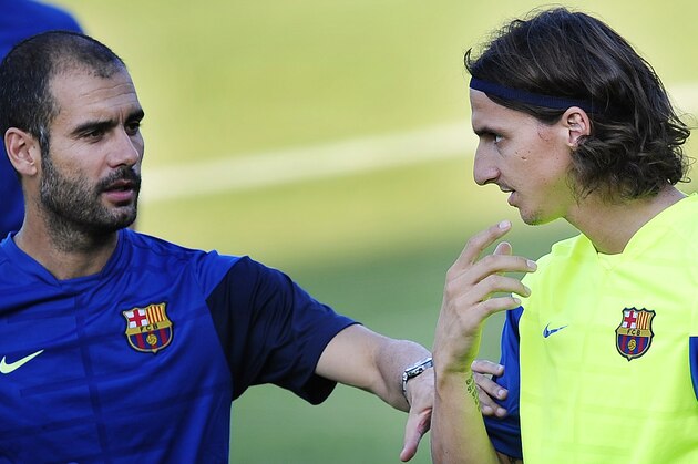 FC Barcelona's Zlatan Ibrahimovic from Sweden, right, speaks with his coach Pep Guardiola during a training session in San Joan Despi, near of Barcelona, Spain, Thursday, Aug. 20, 2009. (AP Photo/Manu Fernandez)