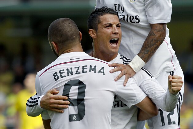 Real Madrid's Cristiano Ronaldo, from Portugal celebrates with Karim Benzema, from France, after scoring against Villarreal during a Spanish La Liga soccer match at the Madrigal stadium in Villarreal, Spain, on Saturday, Sept. 27, 2014.(AP Photo/Alberto Saiz)