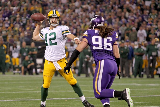 Oct 27, 2013; Minneapolis, MN, USA; Green Bay Packers quarterback Aaron Rodgers (12) throws over Minnesota Vikings defensive end Brian Robison (96) during the third quarter at Mall of America Field at H.H.H. Metrodome. The Packers defeated the Vikings 44-31. Mandatory Credit: Brace Hemmelgarn-USA TODAY Sports