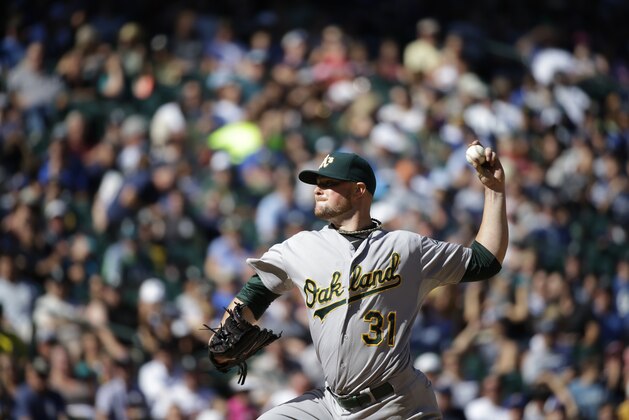 Oakland Athletics starting pitcher Jon Lester throws during a baseball game against the Seattle Mariners, Sunday, Sept. 14, 2014, in Seattle. (AP Photo/Ted S. Warren)