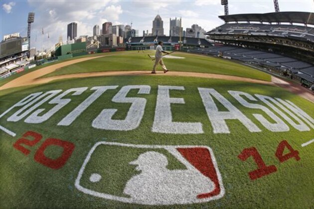 In this image taken with a fisheye lens, the PNC Park ground crew prepare the infield Monday, Sept. 29, 2014, in Pittsburgh, in preparation for Wednesday's National League wild card baseball game between the Pittsburgh Pirates and San Francisco Giants.  It is the second consecutive year the Pirates find themselves in the postseason after suffering through 21 years of futility.(AP Photo/Gene J. Puskar)