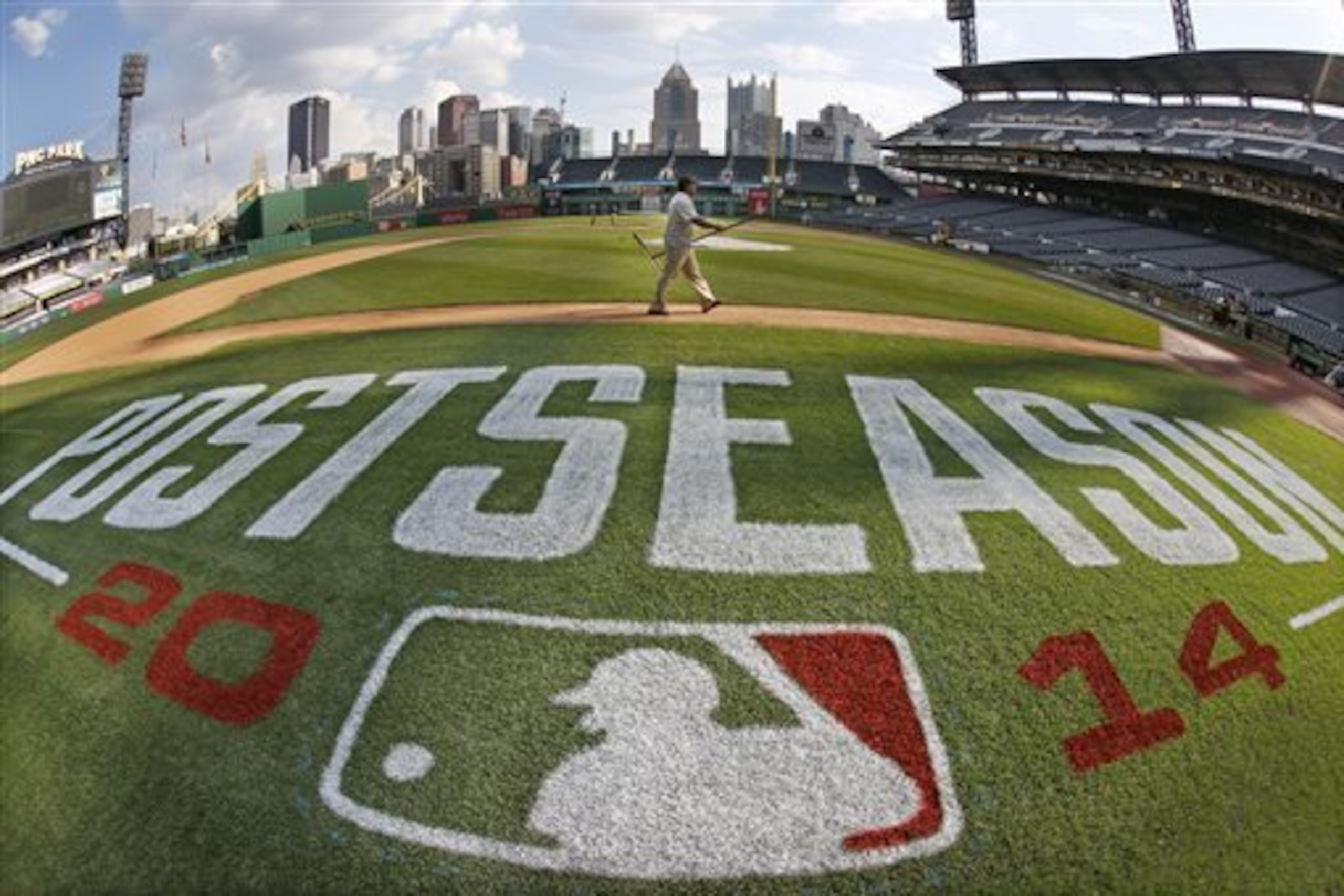 In this image taken with a fisheye lens, the PNC Park ground crew prepare the infield Monday, Sept. 29, 2014, in Pittsburgh, in preparation for Wednesday's National League wild card baseball game between the Pittsburgh Pirates and San Francisco Giants. It is the second consecutive year the Pirates find themselves in the postseason after suffering through 21 years of futility.(AP Photo/Gene J. Puskar) In this image taken with a fisheye lens, the PNC Park ground crew prepare the infield Monday, Sept. 29, 2014, in Pittsburgh, in preparation for Wednesday's National League wild card baseball game between the Pittsburgh Pirates and San Francisco Giants. It is the second consecutive year the Pirates find themselves in the postseason after suffering through 21 years of futility.(AP Photo/Gene J. Puskar)