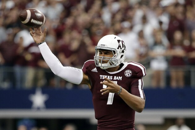 Texas A&M quarterback Kenny Hill passes against Arkansas in the first half of an NCAA college football game, Saturday, Sept. 27, 2014, in Arlington, Texas. (AP Photo/Tony Gutierrez)