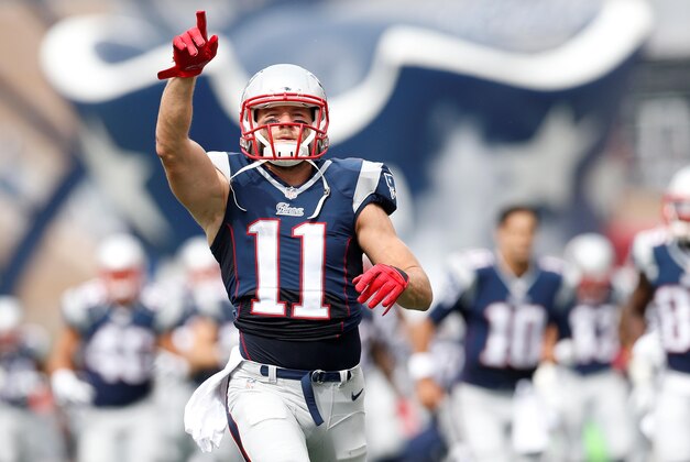Sep 21, 2014; Foxborough, MA, USA; New England Patriots wide receiver Julian Edelman (11) runs onto the field before the game against the Oakland Raiders at Gillette Stadium. Mandatory Credit: Greg M. Cooper-USA TODAY Sports