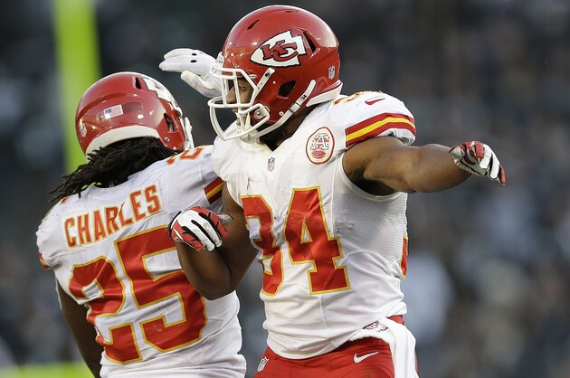 Kansas City Chiefs running back Knile Davis (34) celebrates after running for a 17-yard touchdown with running back Jamaal Charles during the fourth quarter of an NFL football game against the Oakland Raiders in Oakland, Calif., Sunday, Dec. 15, 2013. (AP Photo/Marcio Jose Sanchez)