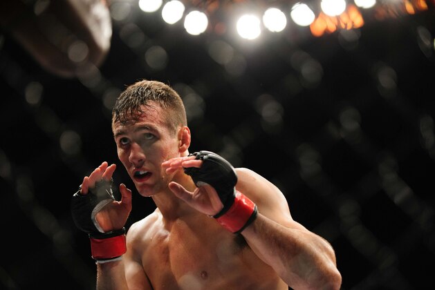 Jun 14, 2014; Vancouver, British Columbia, Canada; Rory MacDonald (red) fights Tyron Woodley (blue) during the Welterweigtht bout at UFC 174 at Rogers Arena. Rory MacDonald defeats Tyron Woodley  via unanimous decision. Mandatory Credit: Anne-Marie Sorvin-USA TODAY Sports