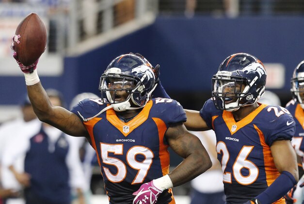 After intercepting a pass from Dallas Cowboys quarterback Tony Romo, Denver Broncos outside linebacker Danny Trevathan (59) celebrates with Rahim Moore (26) Duke Ihenacho (33) during the fourth quarter of an NFL football game Sunday, Oct. 6, 2013, in Arlington, Texas. (AP Photo/Sharon Ellman)