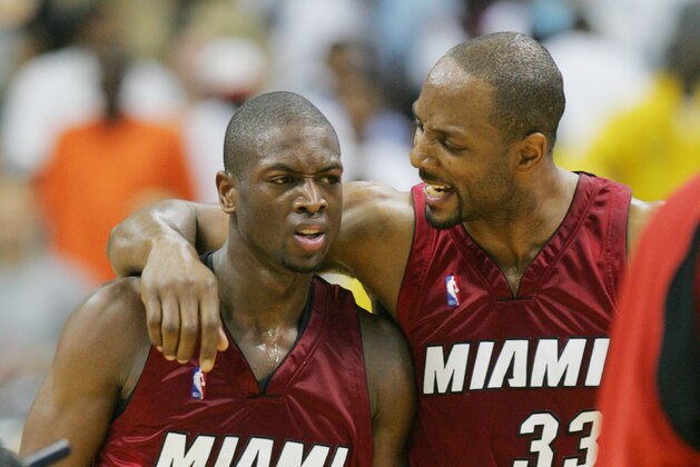 WASHINGTON - MAY 12:  Dwyane Wade #3 and Alonzo Mourning #33 of the Miami Heat celebrate a play against the Washington Wizards in Game three of the Eastern Conference Semifinals during the 2005 NBA Playoffs on May 12, 2005 at the MCI Center in Washington, D.C. The Heat won 102-95 to lead the series 3-0. NOTE TO USER: User expressly acknowledges and agrees that, by dowloading and or using this photograph, User is consenting to the terms and conditions of the Getty Images License Agreement.   (Photo by Jamie Squire/Getty Images)