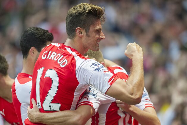 Arsenal's Olivier Giroud celebrates after his team scored scoring against Crystal Palace, during their English Premier League soccer match, at Emirates Stadium, in London, Saturday, Aug. 16, 2014. (AP Photo/Bogdan Maran)