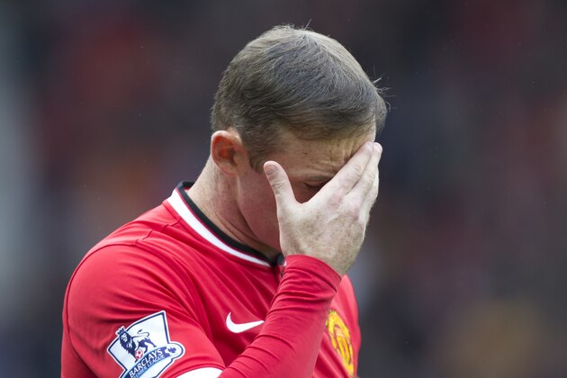 Manchester United's Wayne Rooney takes to the pitch before his team's English Premier League soccer match against West Ham United at Old Trafford Stadium, Manchester, England, Saturday Sept. 27, 2014. (AP Photo/Jon Super)