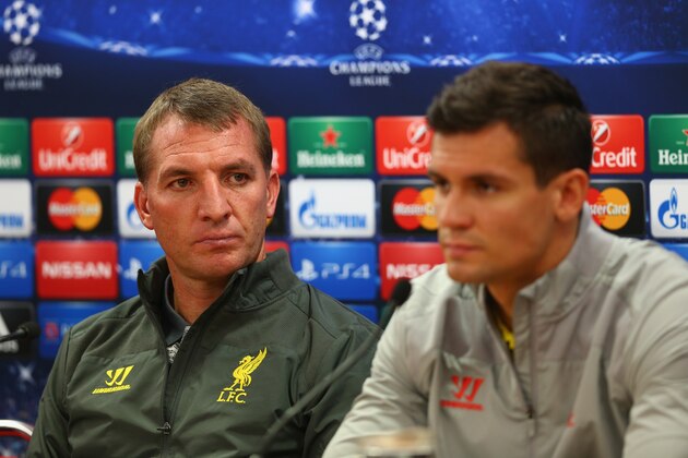 LIVERPOOL, ENGLAND - SEPTEMBER 15:  Liverpool manager Brendan Rodgers deep in thought whilst sitting next to his defender Dejan Lovren during a press conference ahead of their UEFA Champions League group B match against PFC Ludogorets on September 15, 2014 in Liverpool, United Kingdom.  (Photo by Clive Brunskill/Getty Images)