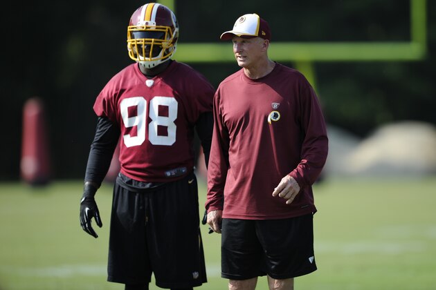 Washington Redskins defensive coordinator Jim Haslett looks on next to linebacker Brian Orakpo (98) during NFL football minicamp, Wednesday, June 18, 2014, in Ashburn, Va. (AP Photo/Nick Wass)