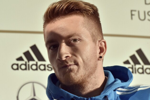 German player Marco Reus watches out of the shadow during a press conference in Kamen, Germany, prior the UEFA EURO 2016 qualifying soccer match between Germany and Scotland, Friday, Sept. 5, 2014. (AP Photo/Martin Meissner)