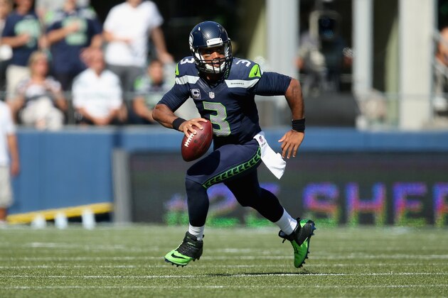SEATTLE, WA - SEPTEMBER 21:  Quarterback Russell Wilson #3 of the Seattle Seahawks runs with the ball against the Denver Broncos at CenturyLink Field on September 21, 2014 in Seattle, Washington.  (Photo by Jeff Gross/Getty Images)