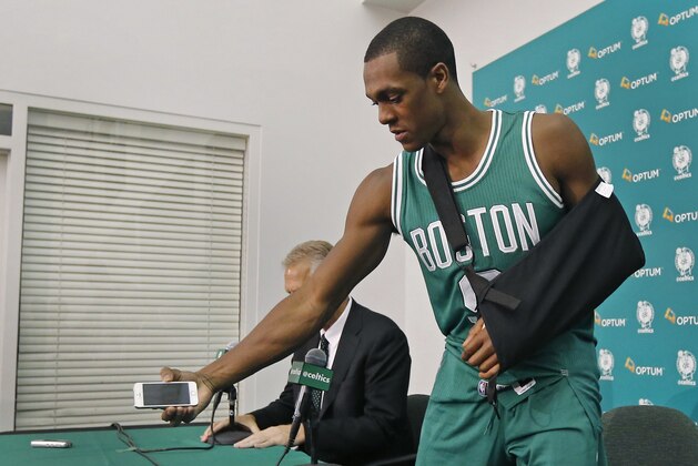 Boston Celtics guard Rajon Rondo picks up his cellphone after taking questions from reporters during NBA basketball media day in Waltham, Mass., Monday, Sept. 29, 2014. (AP Photo/Elise Amendola)