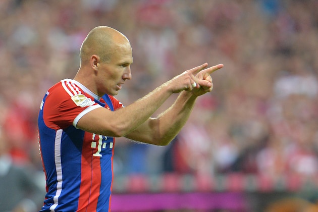 Bayern's Arjen Robben celebrates  during the  soccer match between FC Bayern Munich and VfL Wolfsburg in the Allianz Arena in Munich, Germany, on Friday, Aug. 22, 2014. (AP Photo/Kerstin Joensson)