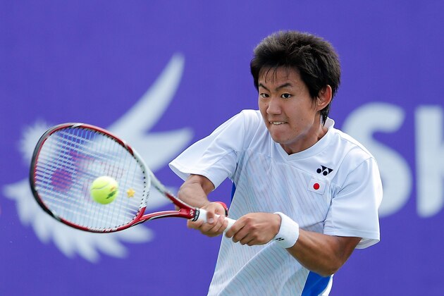 INCHEON, SOUTH KOREA - SEPTEMBER 30:  Yoshihito Nishioka of Japan returns a shot to Lu Yen Hsun of Chinese Taibei during the Tennis Men's Singles Gold Medal Match on day eleven of the 2014 Asian Games at Yeorumul Tennis Courts on September 30, 2014 in Incheon, South Korea.  (Photo by Lintao Zhang/Getty Images)