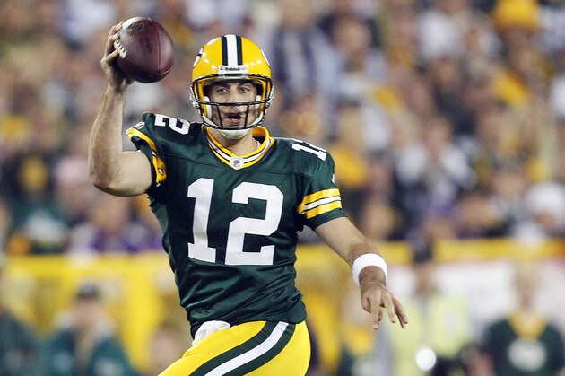 Green Bay Packers quarterback Aaron Rodgers scrambles during the first half of an NFL football game against the Minnesota Vikings on Sunday, Oct. 24, 2010, in Green Bay, Wis. (AP Photo/Jeffrey Phelps)