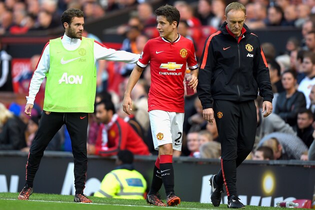 MANCHESTER, ENGLAND - SEPTEMBER 27:  Ander Herrera of Manchester United is consoled by teammate Juan Mata of Manchester United after being substituted in the second half during the Barclays Premier League match between Manchester United and West Ham United at Old Trafford on September 27, 2014 in Manchester, England.  (Photo by Laurence Griffiths/Getty Images)